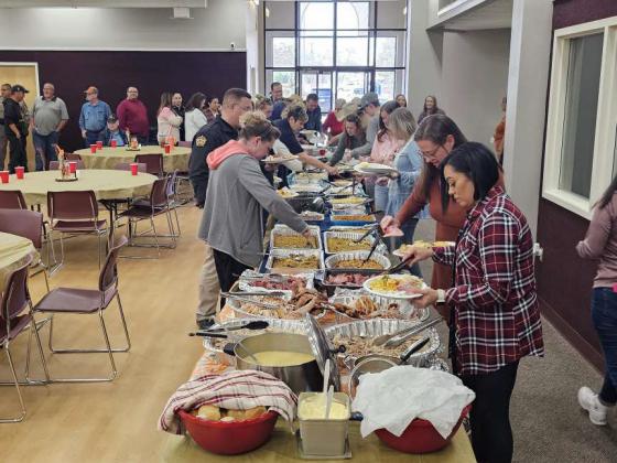 Lamb County employees and their families fill their plates with Thanksgiving foods, at the annual Thanksgiving Luncheon on Friday at the MAC at First Baptist Church in Littlefield. (Staff Photo by Derek Lopez)