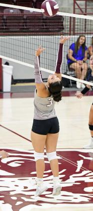 Littlefield setter Bri Valdez sets the ball backwards for a teammate to strike trying to catch the defense out of position, during the first set of the Lady Cats’, 3-0, victory over the Lubbock Titans to open the 2024 season at Wildcat Gymnasium on Tuesday. (Staff Photo by Derek Lopez)