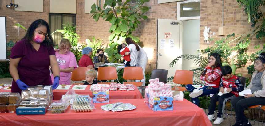 Photos with Santa was held in the Atrium at Lamb Healthcare Center on Tuesday, December 6, 2022. Family members are shown waiting their turn to have a photo taken with the jolly old elf as volunteers sign up the children and make sure there are plenty of cookies and hot cocoa ready to warm the hearts of the children and families. The event was again generously sponsored by Managing and Training Corporation, Tatankas, and Lamb Healthcare Center and Employees. (Photo by Ann Reagan)