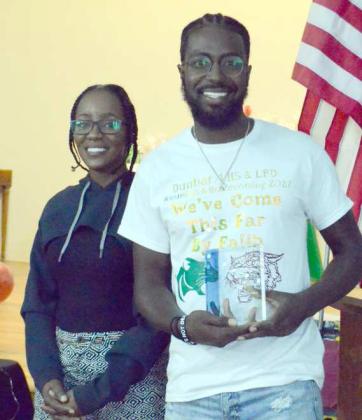 Jeremy Williams (right) received the award for being the first black airplane pilot from Littlefield, Texas. He is standing next to his mother (left) who presented the award to him. (Photo by Samantha Pontius)