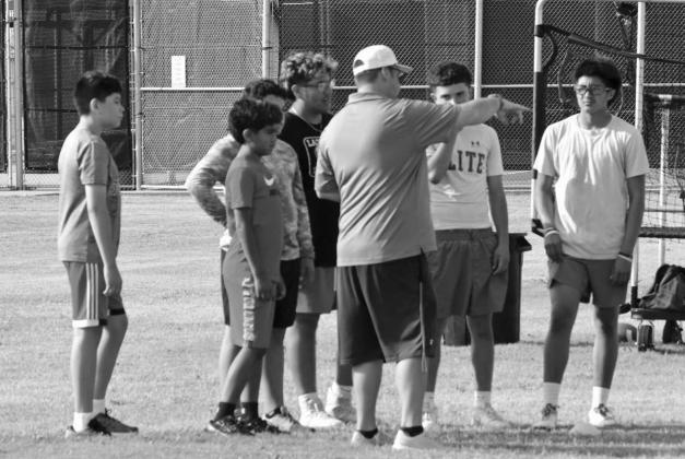 Olton Head Football Coach James Dougherty gives a group of campers instructions during the annual Mustang Youth Football Camp that took place July 27-29. (Photo by Leon Szaniszlo)