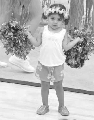 Mini cheerleaders work on stunts with the varsity cheerleaders, during the first session of the Wildcat Cheer Camp on Tuesday at Wildcat Gym. (Staff Photo by Derek Lopez)