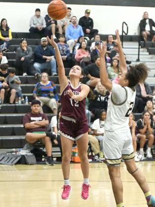 Littlefield senior, Cali Saldana (12), gets to the bucket for a lay-up, during the second half of the Lady Cat’s road victory on Tuesday night over the Lubbock High Lady Westerners. (Staff Photo by Derek Lopez)