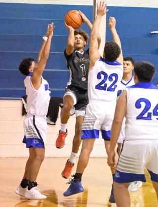 Sudan’s Jaibryn Ornelas (1), puts up a runner from the right side, surrounded by Amherst defenders, during the Hornet’s, 77-34, road victory over Amherst on Tuesday at Bulldog Gym. (Staff Photo by Derek Lopez)