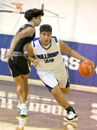 Amherst’s Guillermo Pacheco dribbles past the Sudan defender, during the first half of the Bulldog’s home loss to the Hornets on Tuesday at Bulldog Gym in Amherst. (Staff Photo by Derek Lopez)