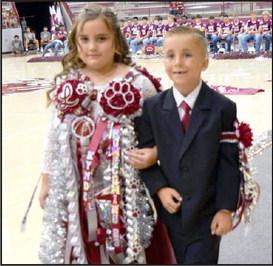 Kyndel Brielee Foley escorted by Travis McKinnon make their way to the stage during the Homecoming Pep Rally at the Littlefield Wildcat Gym on Friday, September 8, 2023. (Photo by Ann Reagan)