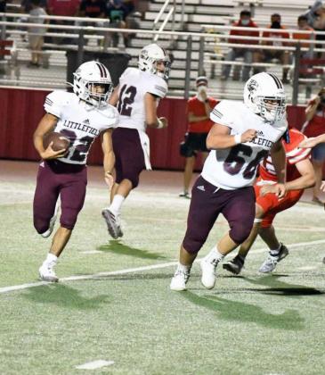 FOLLOWING THE BLOCK – Littlefield senior slotback, Xavier Esquibel (22), gets behind his blocker Ace Acevedo (66), for a run around the right side, during the Wildcats, 28-14, loss to the Denver City Mustangs on Friday night. (Staff Photo by Derek Lopez)