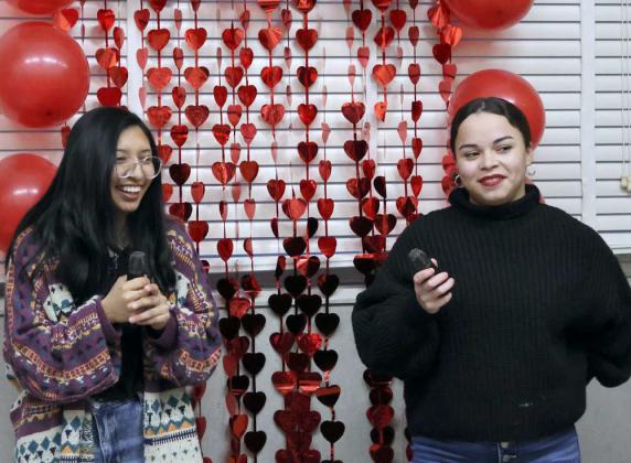 Cassie Caudillo and Assistant Librarian , Ambrosia Nelson have some fun singing Karaoke at the Lamb County Library Anti-Valentine Party on Thursday, February 15, 2024. The theme of the party was, ' No valentine, No problem!' We are going to have a party not celebrating Valentine's Day. (Photo by Ann Reagan)