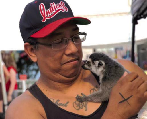 This vendor brought his pet Ring Tailed Lemur which was a hit with his customers. (Photo by Ann Reagan)