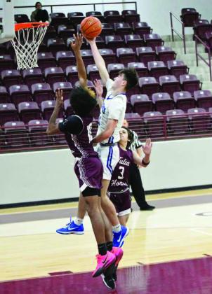 Olton’s Brady Azam (11) gets to the bucket for a lay-up, during the first half of the Mustangs’, 5225, victory over Tulia, in their opener at the Wildcat Classic on Monday. (Staff Photo by Derek Lopez)