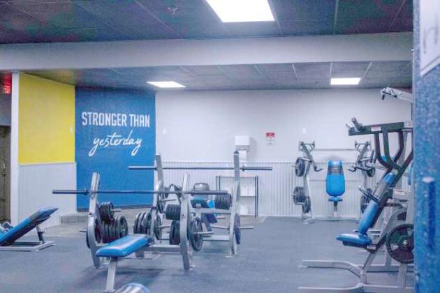 While customers work out, inspirational slogans are displayed at Energy Fitness. (Staff Photo by Madison Vidales)