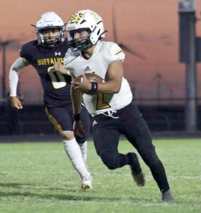 Springlake-Earth junior, Froylan Agundiz, looks to create a spark for the offense as he takes off on a run, during the second quarter of the Wolverine’s, 40-35, loss to Petersburg on Friday at Buffalo Stadium. (Photo by Hannah Alvarez)