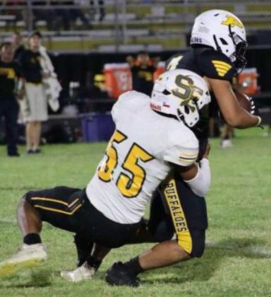 Springlake-Earth senior, Nehemiah Castillo, makes a tackle, during the Wolverine’s, 40-35, loss to Petersburg on Friday at Buffalo Stadium. (Photo by Hannah Alvarez)
