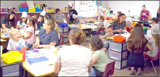 LITTLEFIELD PRIMARY students and their families create art projects and enjoy chips and salsa at the Family Reading Night on Thursday, September 28, 2023. The chips and Salsa were generously donated by Loco’s Restaurant of Littlefield. (Photo by Ann Reagan)