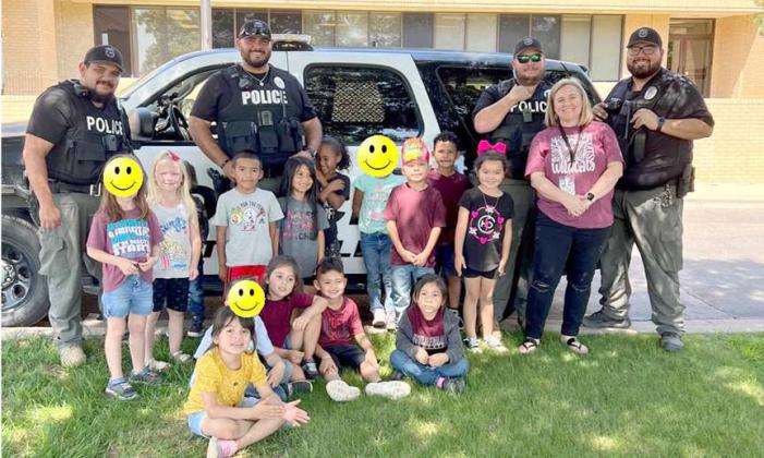 The LPD visited with the Kindergarten students on Tuesday, Sept. 6, 2022. The class has been learning about community workers and rules that society has to follow at home, school and in the community. (L to R): Officer Shane Martinez, Officer Jonathan Martinez, K9-Officer Matt Howard, Lt. Samuel Garcia and Sgt. Pedro Cruz. (Submitted Photo)