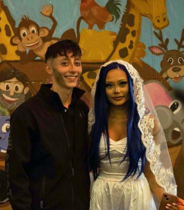 Dressed as Victor and Emily from ‘The Corpse Bride,’ the two pose for a picture in front of Noah’s Arc at the Hillcrest Funeral Home’s Trunk or Treat on Oct. 31. (Staff Photo by Madison Vidales)