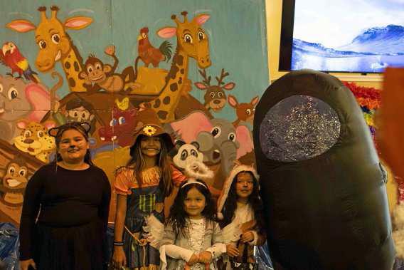 Two animals, an angel, a scarecrow and an ‘Among Us’ crew member pose in front of Noah’s Arc at the Hillcrest Funeral Home’s Trunk or Treat on Oct. 31. (Staff Photo by Madison Vidales)