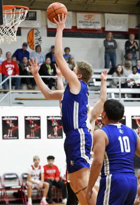 Johnathan Cooper drops in a lay-up during the first quarter of the Mustang’s Whitharral Tournament Championship victory over the host team Panthers on Saturday night. (Staff Photo by Derek Lopez)