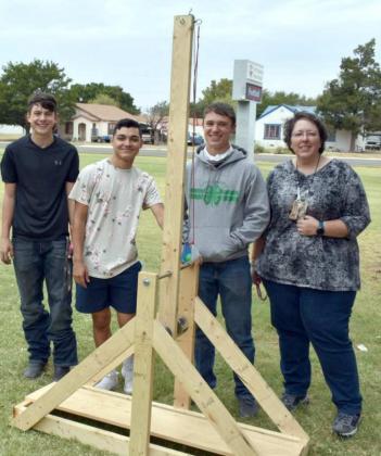 SHOWING OFF TREBUCHET CREATION—These three Littlefield High School Junior students are shown with the trebuchet they built as a project for Physics Teacher Jennifer Crouch’s class. The students are, left to right, Austin Tyler, Cruz Avila, and Jacob Turpen, who stand with their Physics Teacher, Jennifer Crouch. (Photo by Krista Carpenter)