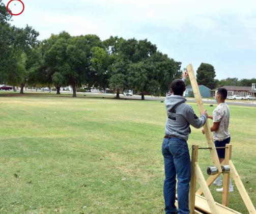 PROJECTILE LAUNCHED BY TREBUCHET—Two Littlefield High School Junior students Jacob Turpen and Cruz Avila watched as the projectile was launched into the air from their trebuchet. It is the small dot in the upper left corner of the photo. (Photo by Krista Carpenter)