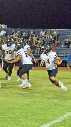 LOOKING FOR A HOLE - Sudan junior quarterback, Trent Wilson (1), carries the ball for the Hornets, during the second half of their, 49-0, loss to the Olton Mustangs on the road on Friday night. (Staff Photo by Samantha Pontius)