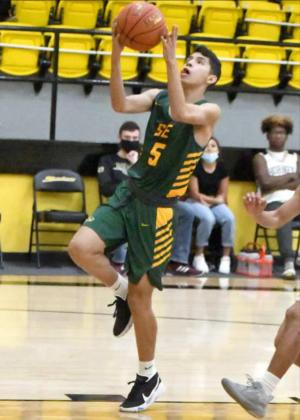 EASY POINTS — Springlake-Earth guard, Alex Alvarez, drops in a quick lay-up, during the first half of the Wolverines’ road win against the Hornets on Saturday. (Staff Photo by Derek Lopez)