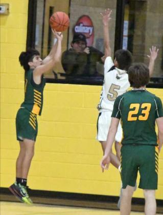 BOMBS AWAY— Springlake-Earth guard, Evan DeLeon (1), fires up a corner three from the left wing over the outstretched hand of Sudan’s Michael Limon, during the second half of the Wolverines’ road win against the Hornets on Saturday. (Staff Photo by Derek Lopez)