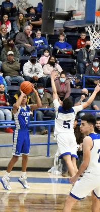 SNIPER — Olton senior, Israel Santillan (5), fires up a corner three over the outstretched hand of Farwell’s Jonathan Mora, during the second half of the Mustang’s comeback victory over the Steers on the road on Friday. (Staff Photo by Derek Lopez)