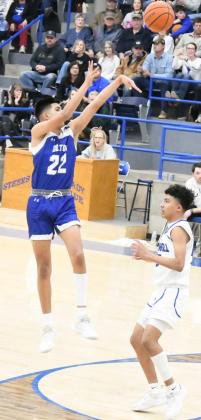 LETTING IT FLY – Olton senior, Chris Urbina (22), fires up a jumper from the top of the key, during the first half of the Mustangs’ victory over Farwell on the road on Friday. The win gave Olton the District title. (Staff Photo by Derek Lopez)