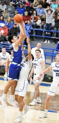 FIGHTING THROUGH CONTACT – Olton’s Joe Canchola (5), goes up strong in the paint, over Farwell’s Leo Nunez (12), during the first half of the Mustangs victory over the Steers on Friday. (Staff Photo by Derek Lopez)