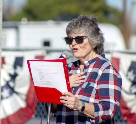 Former Army Nurse Kim Billingsley reads the program at the event honoring Littlefield veterans on Nov. 10, 2024. (Staff Photo by Madison Vidales)