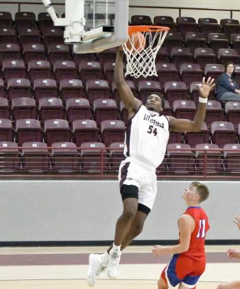 IGNITING THE CROWD —Littlefield senior forward, Tyree Jones (54), pokes away a steal and gets out on the break, finishing with a one-hand slam on the breakaway to fire up the crowd at Wildcat Gym, during the first half of the Wildcats’ victory over Sundown on Tuesday. (Staff Photo by Derek Lopez)
