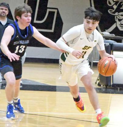 LOOKING TO PENETRATE - Springlake-Earth’s, Isaiah Tovar, puts the ball on the hardwood as he looks to penetrate to the basket, during the second half of the Wolverines’ 1A Bi-district loss to the Wildorado Mustangs on Tuesday at Canyon Randall. (Staff Photo by Derek Lopez)