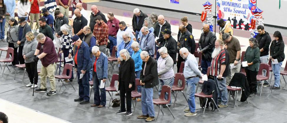 Those in attendance stood and observed a moment of silence during the Littlefield High School Veteran’s Day Program at Wildcat Gymnasium. (Staff Photo by Derek Lopez)