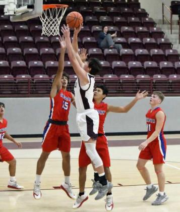 GOING UP STRONG—Littlefield senior forward, Chris Brown (44), puts up a tough lay-up over the Sundown defense in the lane, during the first half of the Wildcats’ victory over the Roughnecks on Tuesday. (Staff Photo by Derek Lopez)