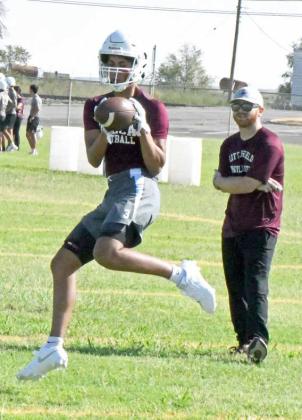 Littlefield sophomore receiver catches a pass during route running drills, during the first day of two-a-days on Monday. (Staff Photo by Derek Lopez)