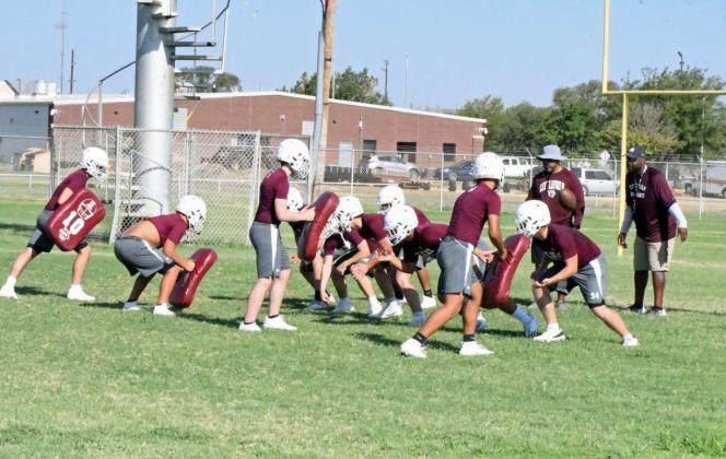 Littlefield’s offensive linemen are shown working on blocking schemes, during the first day of two-a-days on Monday. (Staff Photo by Derek Lopez)