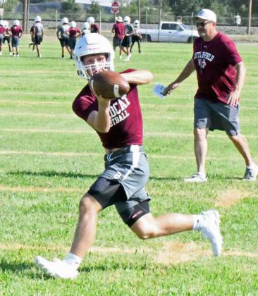 Littlefield senior tailback, Major McNeese, catches a pass out of the backfield, during route running drills on the first day of two-a-days on Monday. (Staff Photo by Derek Lopez)
