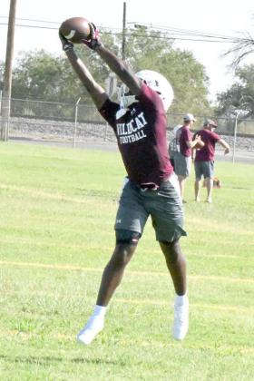 Littlefield senior receivver, Eizeah Coleman goes up and reels in a high pass, during route running drills on the first day of two-a-days on Monday. (Staff Photo by Derek Lopez)