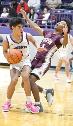 Littlefield senior guard, MJ Randle (1), takes a charge against Dimmitt in the second half of the Wildcats’, 81-44, road victory over the Bobcats on Friday. (Staff Photo by Derek Lopez)