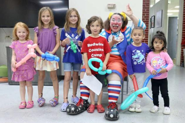 These are the kids that came to the Skeeter the Clown show at the library. (left to right) Abigail Stevenson, Brinn Redwine, Bailey Redwine, Baron Redwine, Skeeter the Clown, Khali Sanchez, and Sienna Hernandez. (Photo Courtesy of Olton Chamber of Commerce)