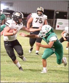 SHAKING OFF THE DEFENSE -Sudan quarterback, Trent Wilson, stiff arms a Ropes defender on his way to a solid gain in the second half of the Hornets’, 24-21, victory over the Eagles on Friday. (Staff Photo by Derek Lopez)