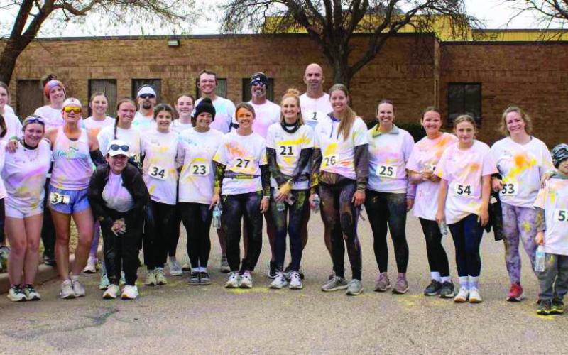 Participants of the 5k Color Run pose for a group photo on March 28, 2026. (Photo by Madison Vidales)