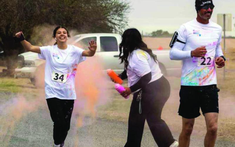 Runners get blasted with color during the 2026 LHC 5K Color Run on Saturday. (Photo by Madison Vidales)