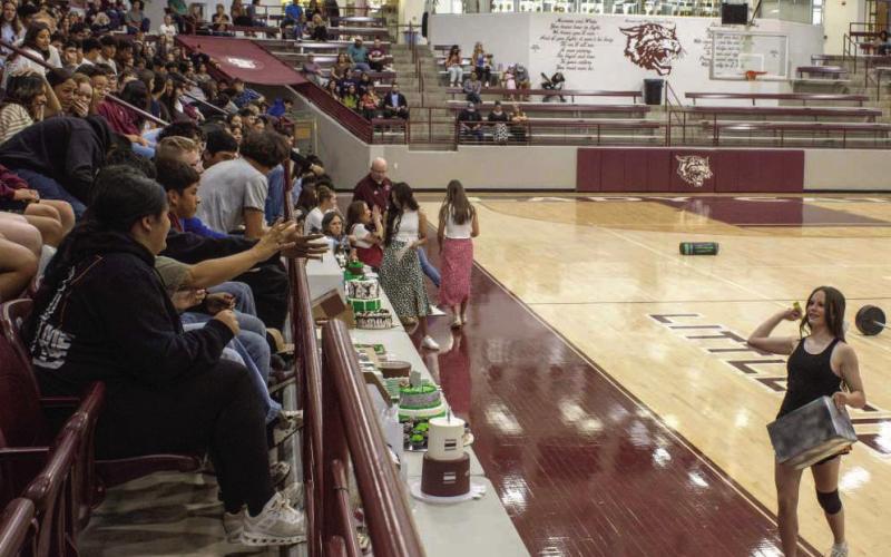 Bella Enloe throws candy at the crowd during cheer tryouts on April 1, 2026. (Photo by Madison Vidales)