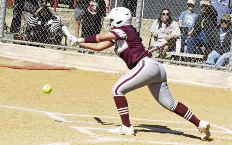Littlefield senior, Tailyn Gomez, lays down a bunt to get on base in the top of the seventh inning on Saturday, during the Lady Cats, 19-18, victory over Muleshoe in their first meeting of district play. (Staff Photo by Derek Lopez)