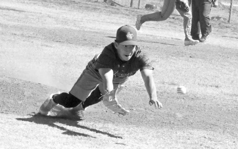 Springlake-Earth’s Froylan Agundiz, comes off the mound and makes a diving catch on a popped up bunt for an out, during the top of the first inning of the Wolverines’ loss to the WTX Tornadoes on Friday at the Lamb County Classic. (Staff Photo by Derek Lopez)