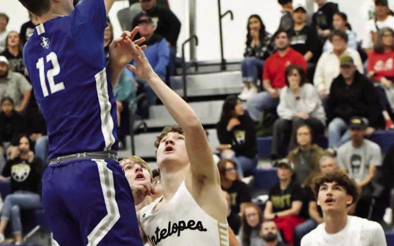 Olton’s Brady Azam (12) drops in a lay-up for twoof- his team-high 16 points, during the Mustang’s, 70-31, victory over Post in the Class 2A-DI Bidistrict championship game at Liberty HS on Tuesday. (Staff Photo by Derek Lopez)